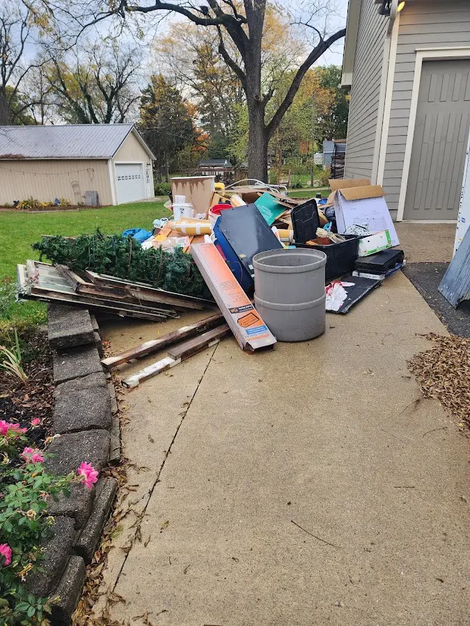 Dumpster being loaded with debris for Commercial Dumpster Rental in Camp Springs